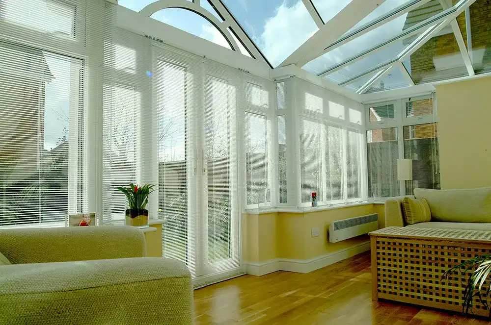 White upvc T-shaped Conservatory by Adam Window Centres, Tuckton
